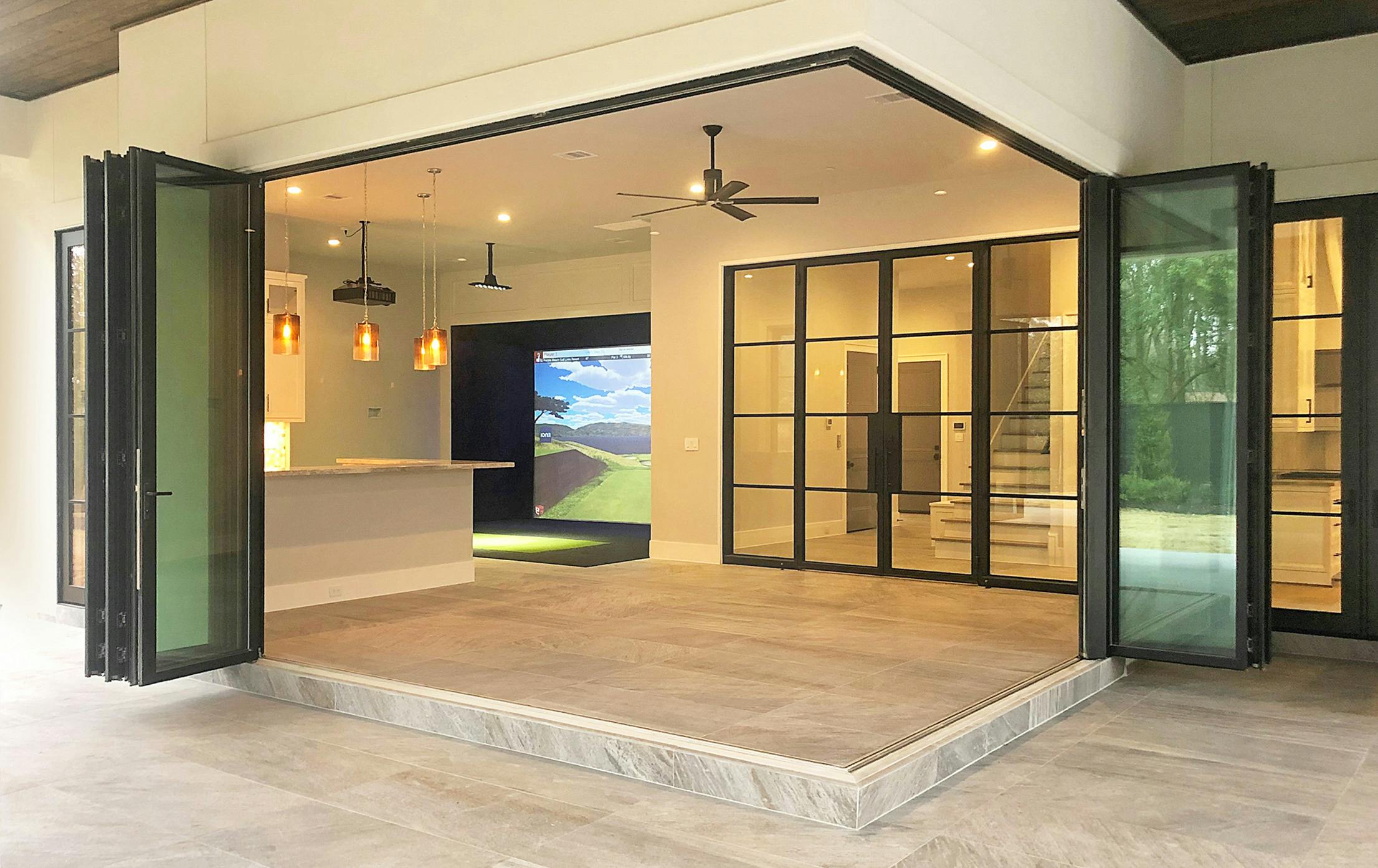 Modern open-concept living space featuring zero corner folding glass doors