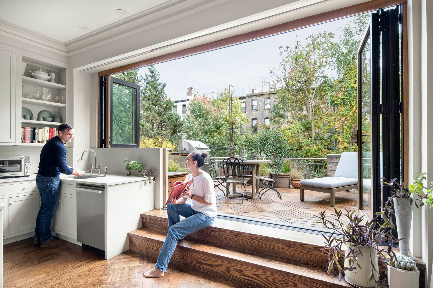 NanaWall wood-clad folding glass wall system at a Brooklyn residence, opening the interior living space to an outdoor terrace
