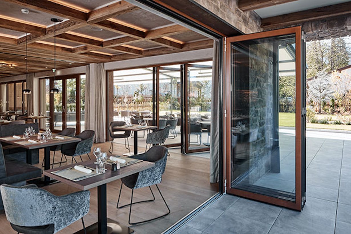 A restaurant with large folding glass doors