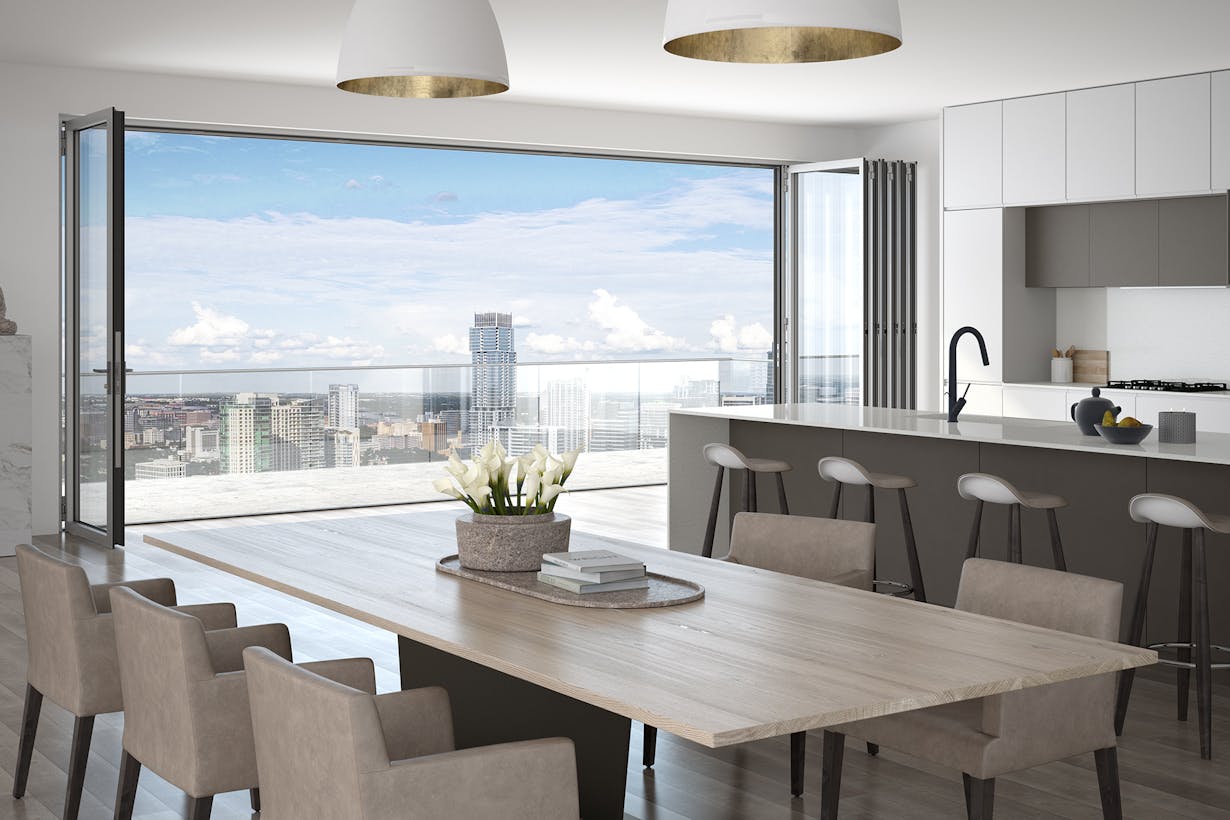 A kitchen with a table and chairs and a view of the city