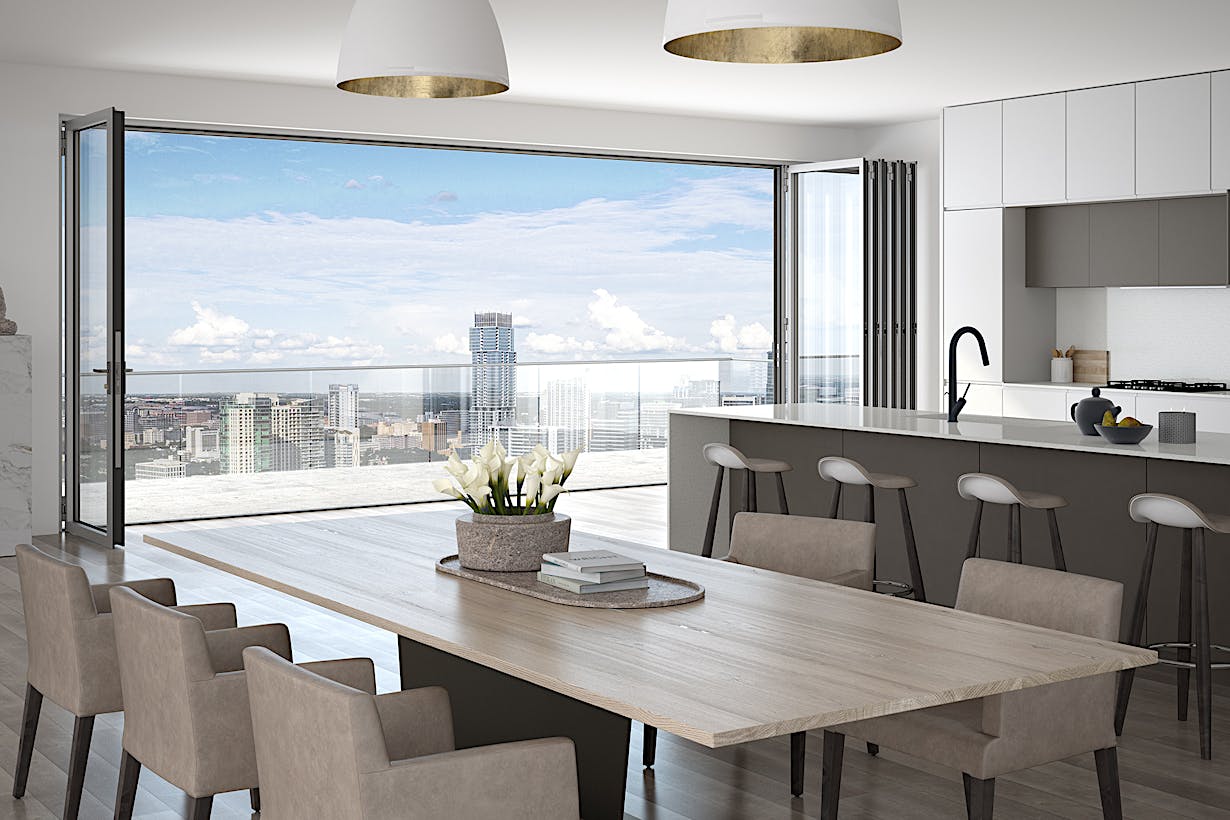 A kitchen with a table and chairs and a view of the city