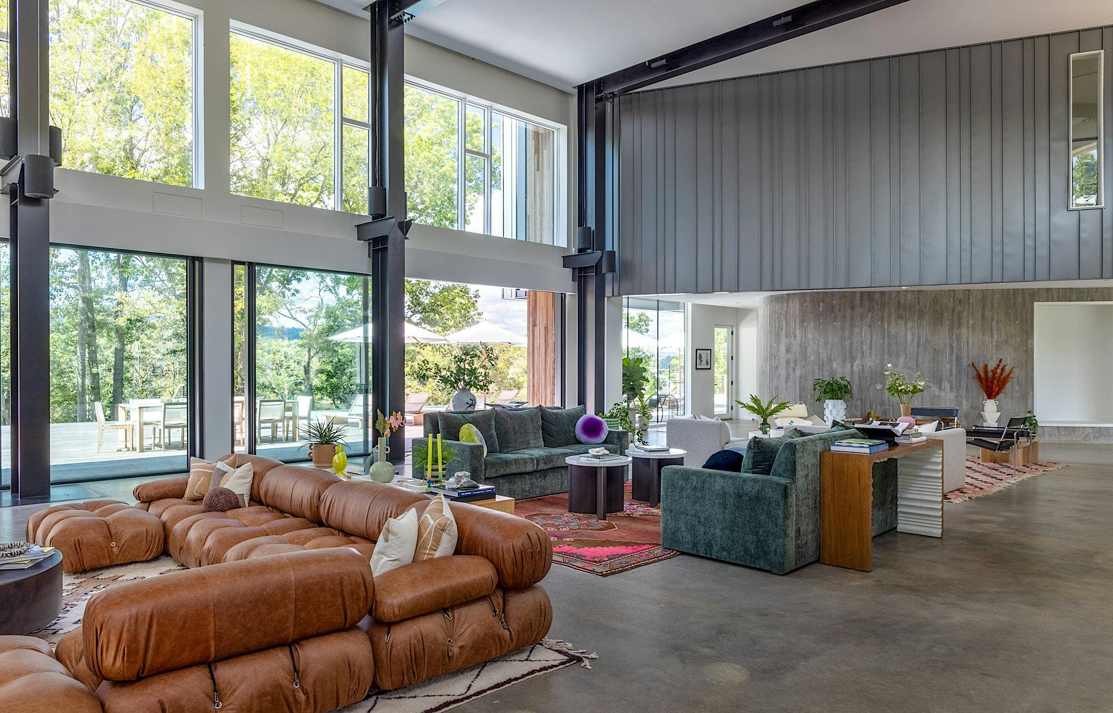 Modern living room with transom windows, opening glass doors, and direct access to the patio.