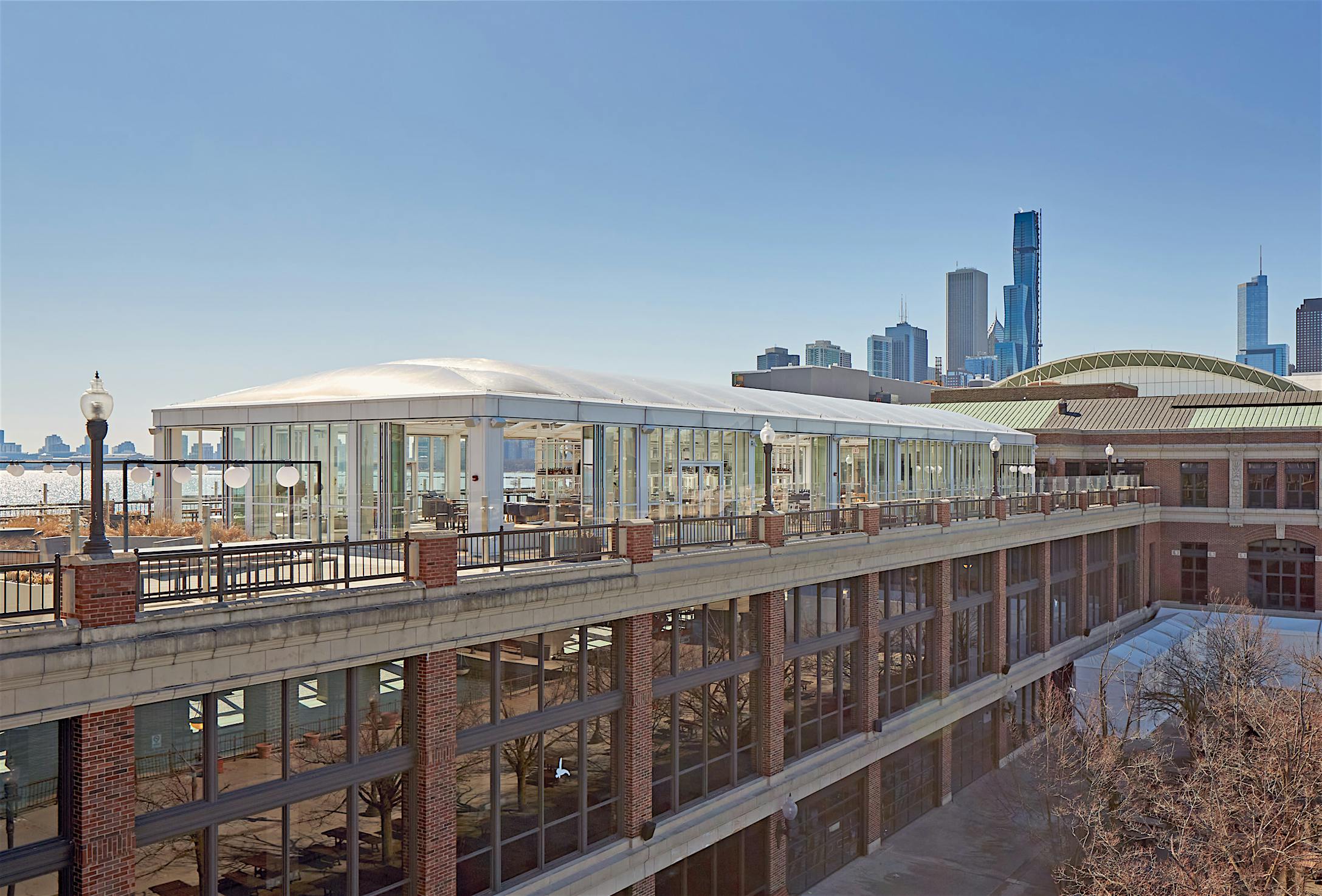Opening glass doors in modern lounge designed for high weather performance and city views.