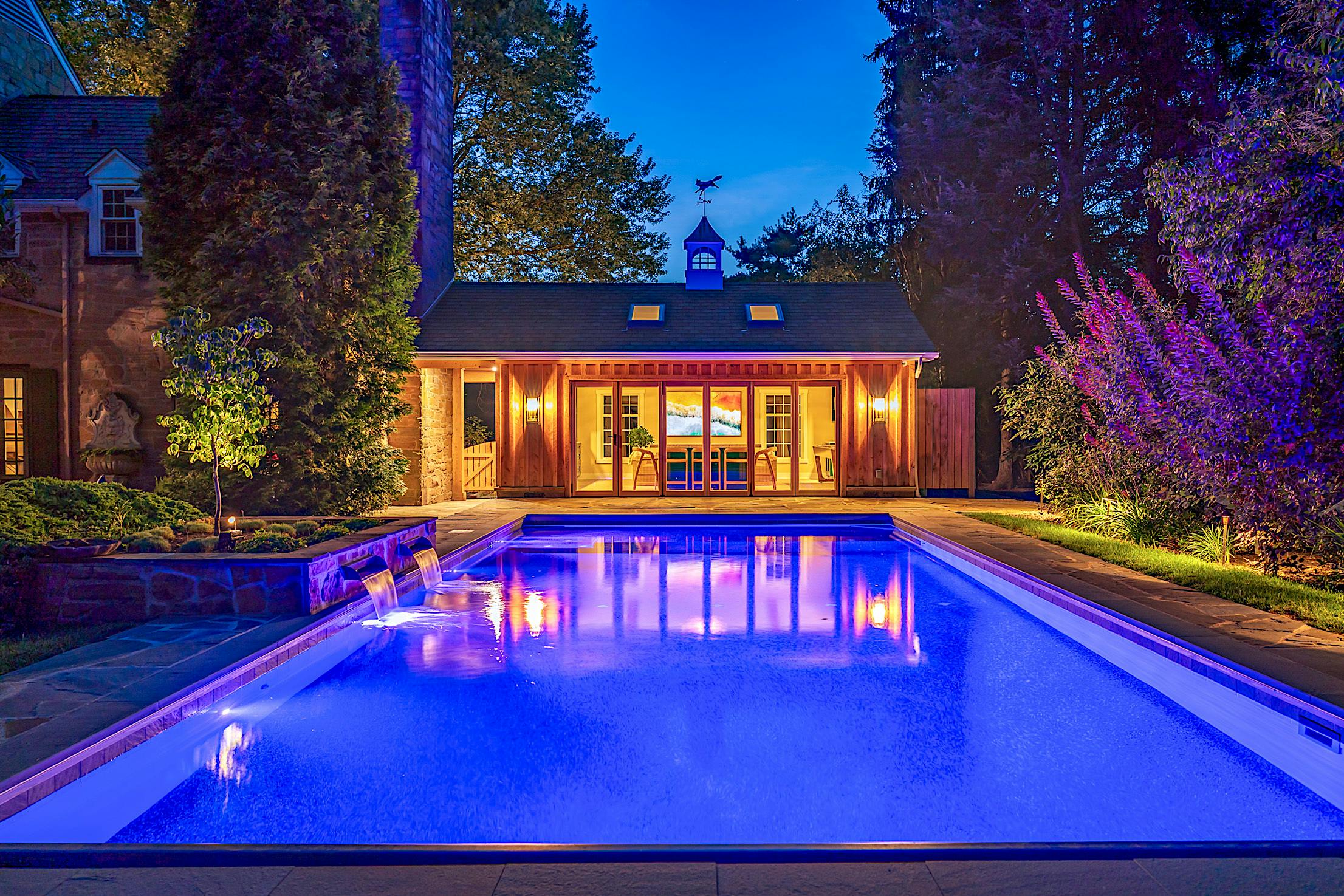 outdoor living with pool house and wood framed folding door