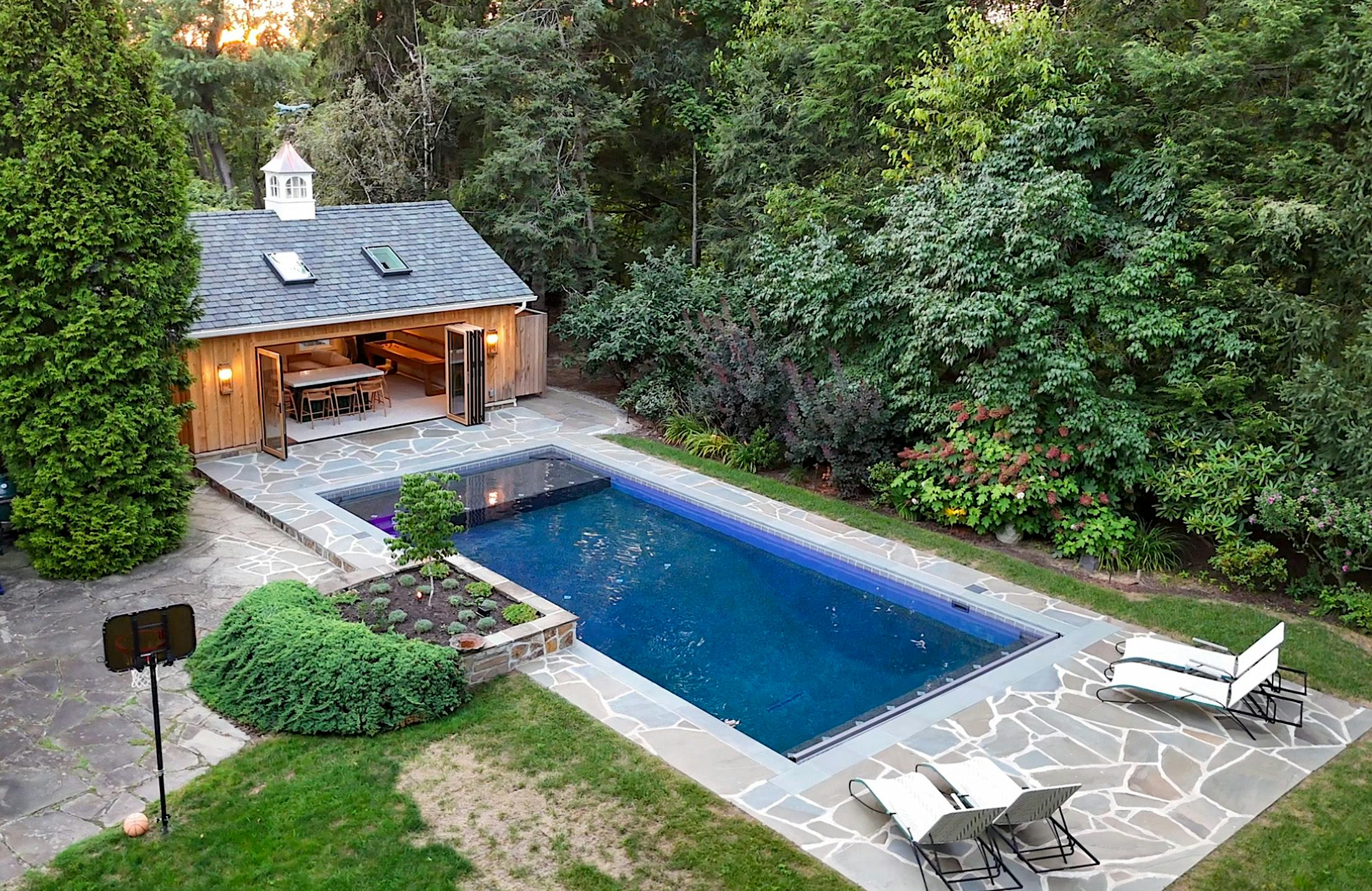 contemporary pool house design with wood framed bifold door system