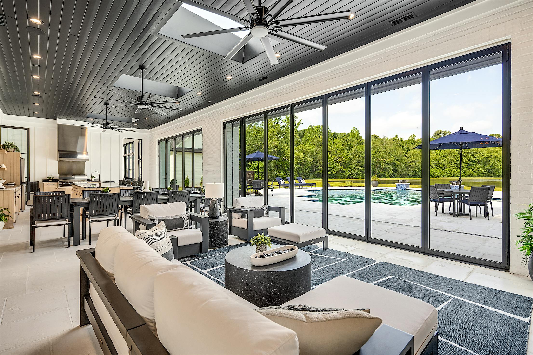 Contemporary Arlington TN retreat featuring NanaWall NW Aluminum 640 ultra-slim folding glass wall fully open to patio