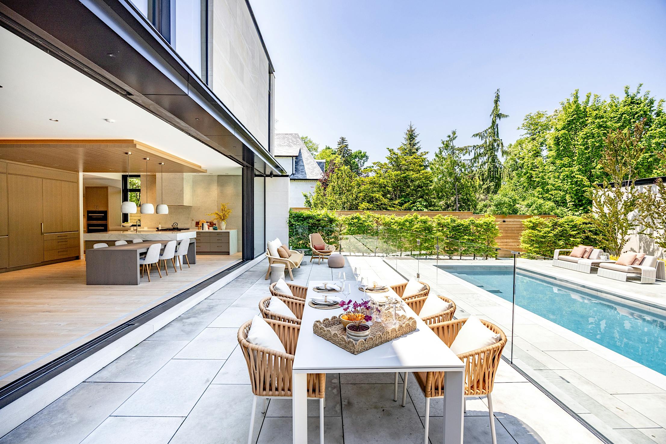 indoor outdoor living with minimal sliding glass wall system