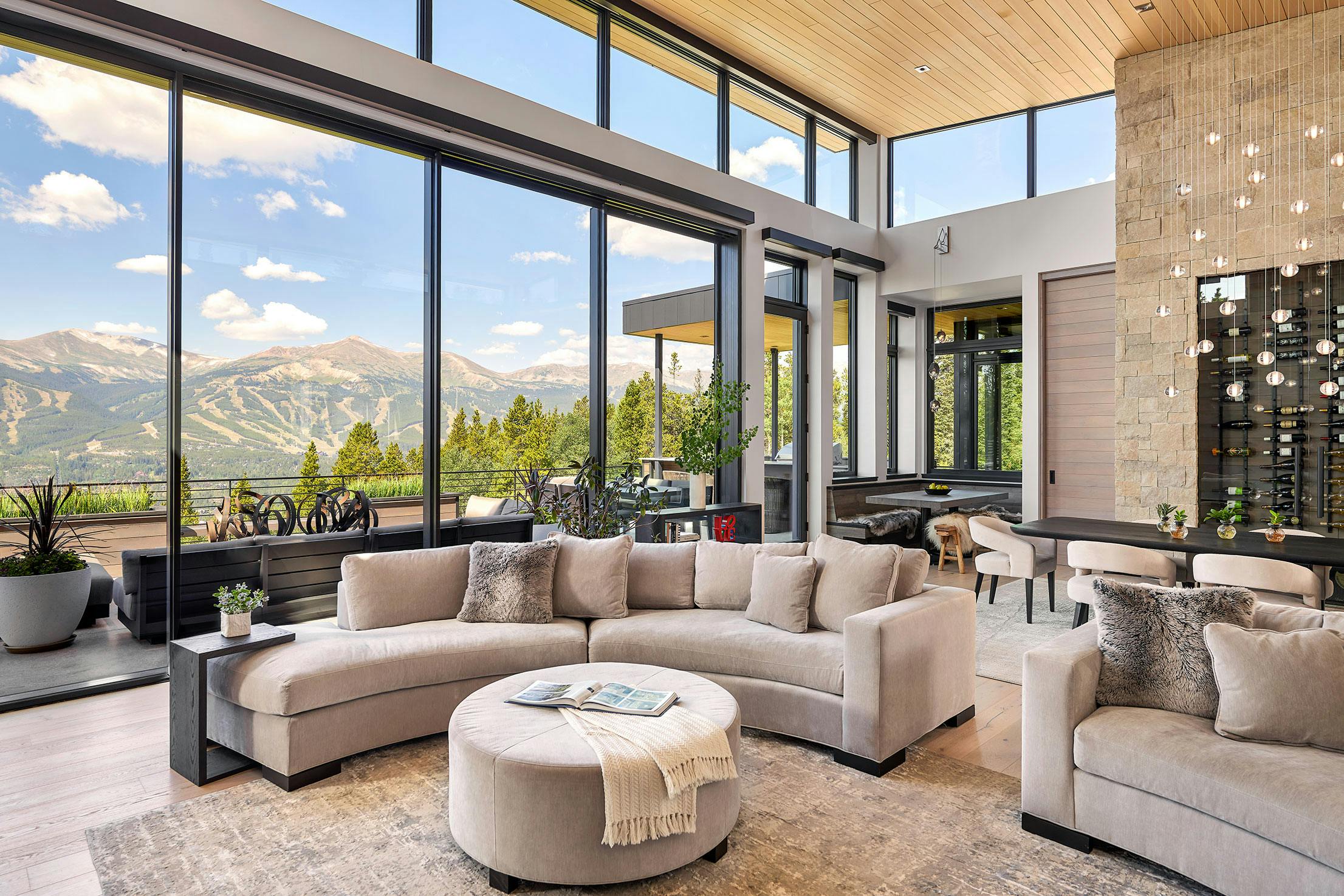 Modern living area with large sliding glass doors opening to patio, creating bright indoor-outdoor living and showcasing clean contemporary architectural style