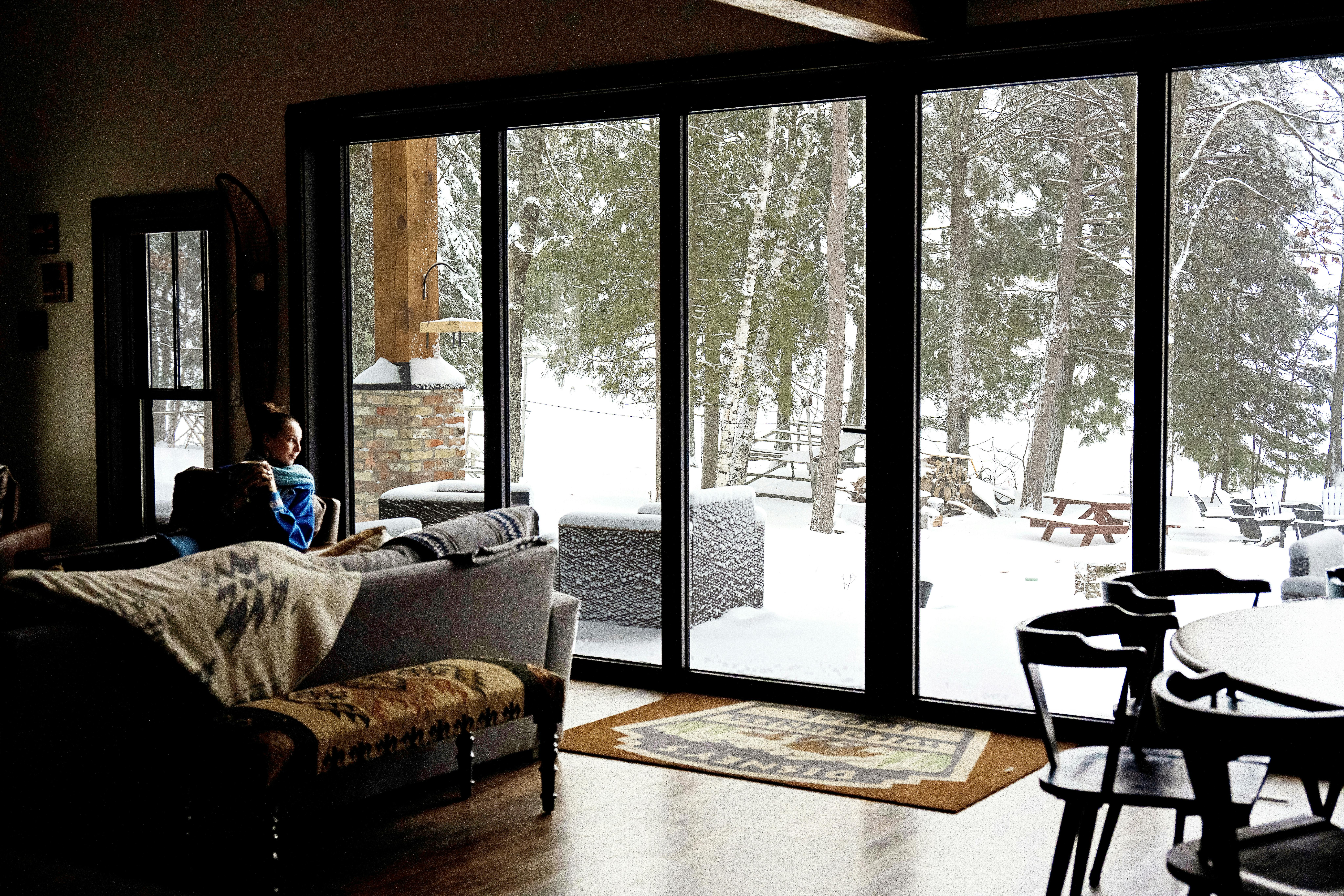 NanaWall aluminum glass wall system closed, showing thermal performance and weather protection in a snowy residential setting