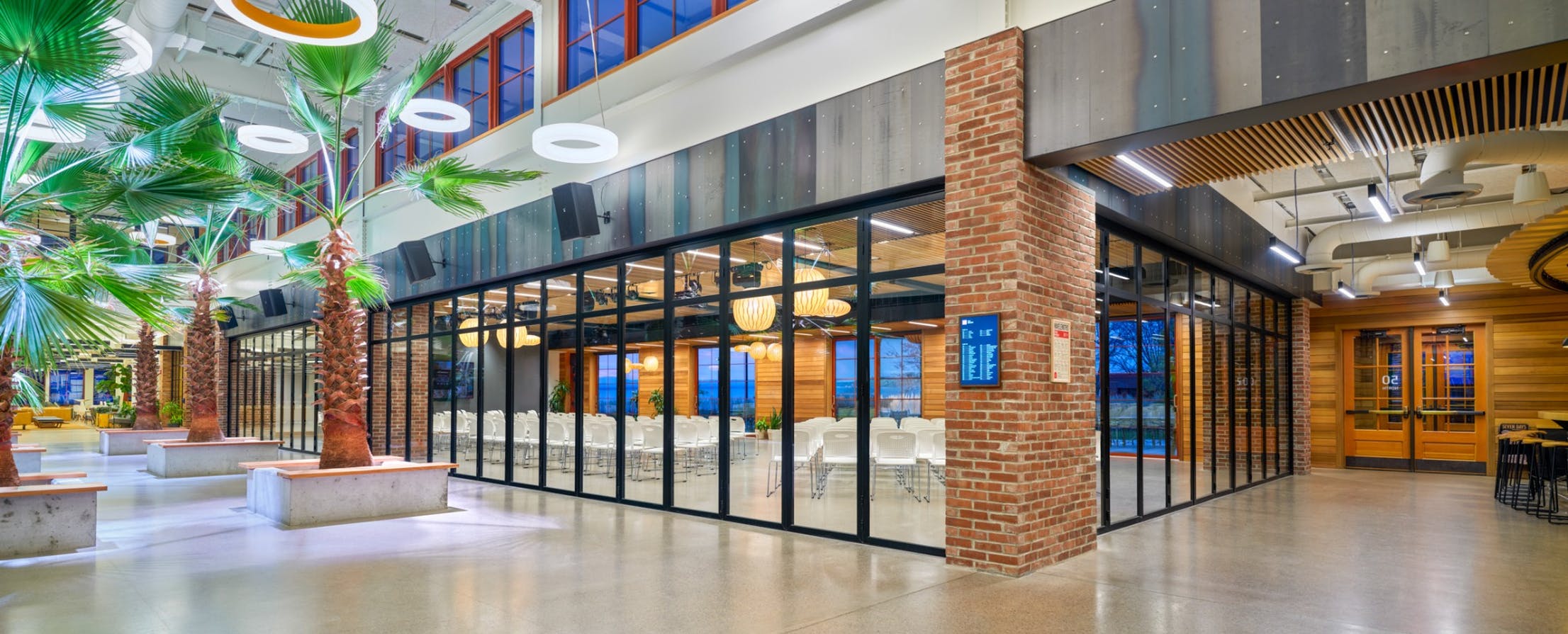 Interior folding glass walls across two sides of a corner